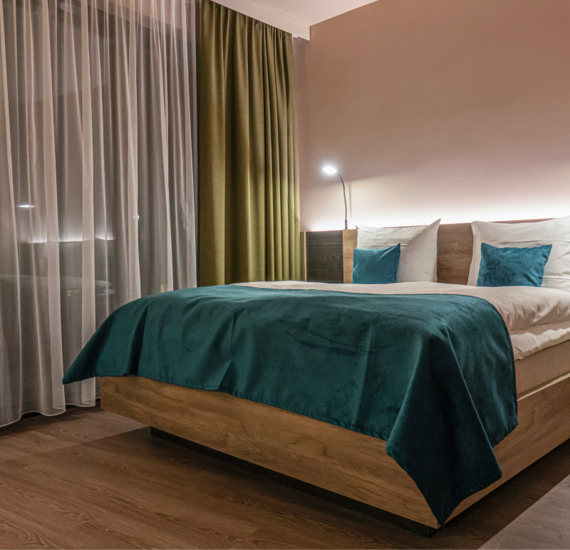 Hotelbett eines H24 Hotels in Bernau. Blaue Decke liegt am Bettende